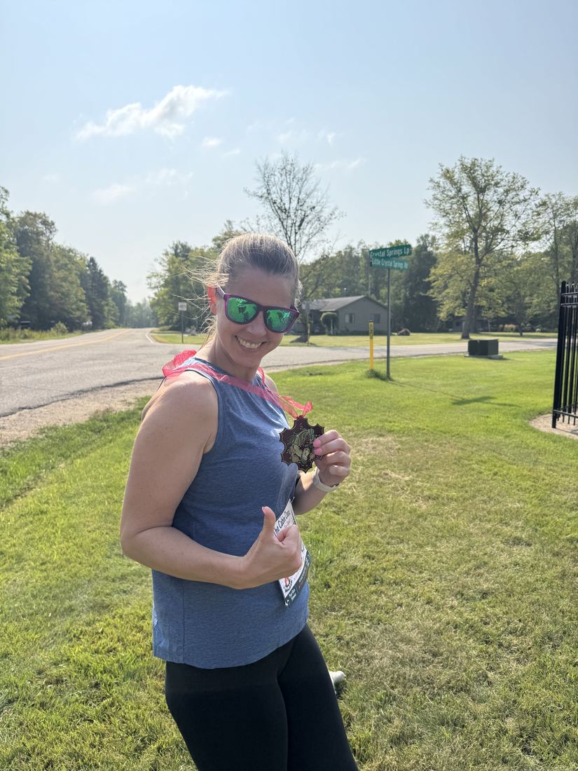 An athlete on the gravel road course giving a thumbs up